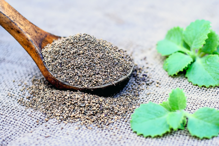 ajwain-seeds-in-a-wooden-scoop-with-some-leaves